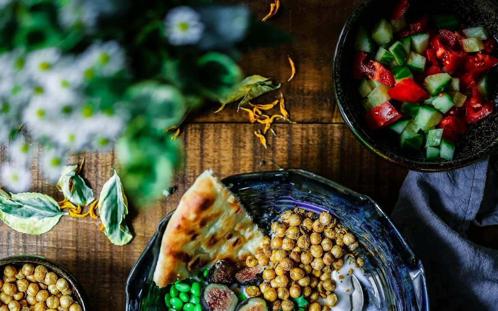 A bowl of roasted chickpeas, edamame, yogurt and fresh vegetables